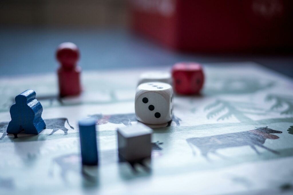 Meeples and Dice on a Game Board